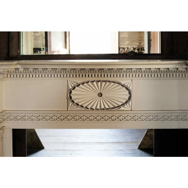 Antique, mid-19th century, Federal style painted wood mantel of impressive scale having paired, reeded column jambs....