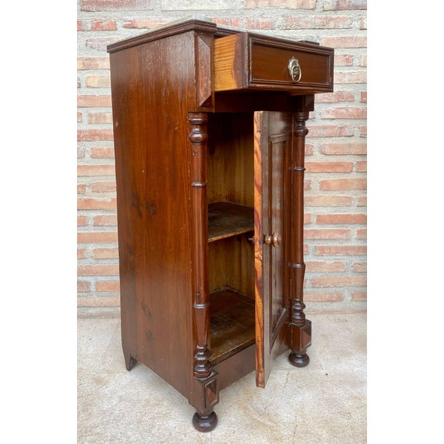 Pair of French Louis XVI cupboards with finely decorated side columns, from the late 19th century. White marble top....