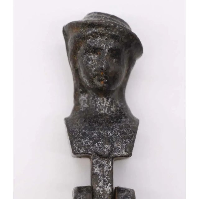 The antique figural black cast iron window shutter drop pull is a delightful ornate accent. Its detailed design and...