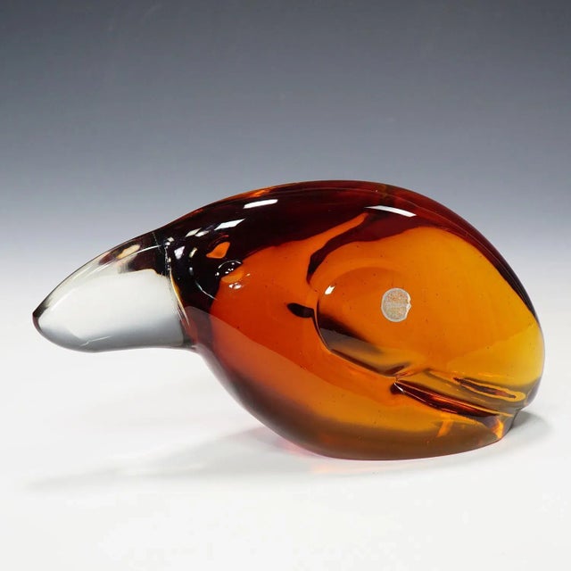 A heavy sculpture of a toucan in orange and clear glass. Designed by glass sculptor Livio Seguso ca. 1960. On the base...