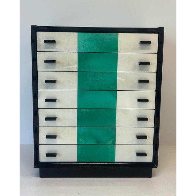 Elegant Italian chest of drawers from the 1950s, featuring a refined black lacquered structure. The drawer fronts are clad...