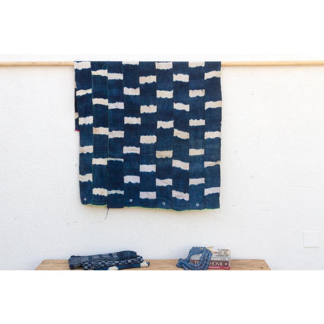 A masterwork of Malian textile heritage featuring deep indigo saturation and symbolic geometric motifs. Originating from...