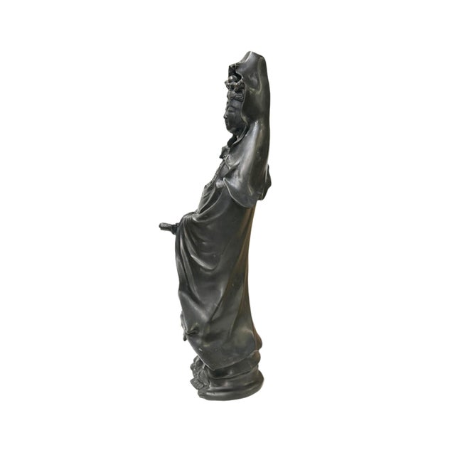 This Vintage Chinese Black Metal Bodhisattva Kwan Yin Buddha Statue is a beautifully crafted representation of the revered...