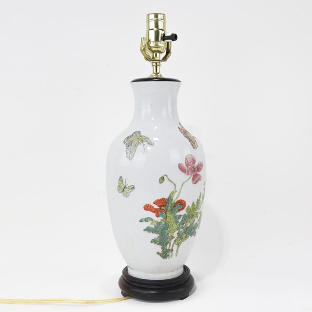 This elegant Chinese porcelain lamps features hand-painted blooming poppy flowers in soft pinks, reds, and purples, set...