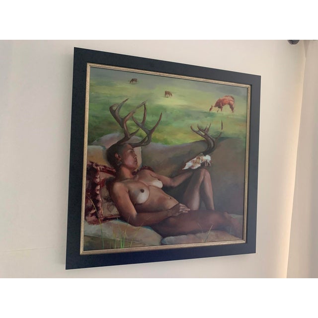 The artwork depicts a reclining figure adorned with antlers, evoking a sense of myth and nature intertwined. The soft,...
