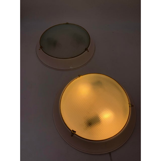 Lamps attributed to Fontana Arte. Sold as a pair. Ceiling or wall lamp, featuring a simple and functional design typical...