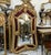 Make a dramatic statement with this grand French Rococo–style mirror, beautifully crafted with an elaborate gold leaf...