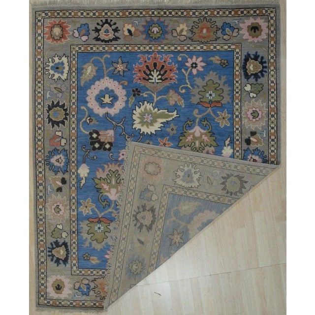 This blue wool rug features a hand knotted pile weave and is designed in the Nain style. It displays a classic traditional...