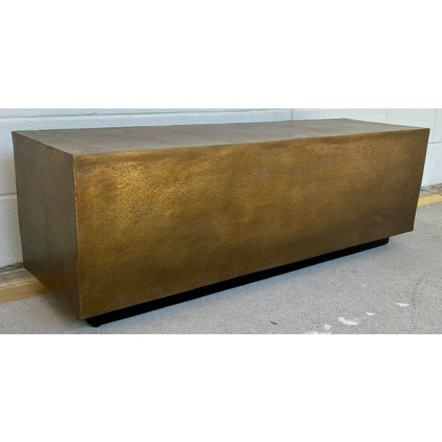 Original retail $3240, stylish Currey & Co. Modern Antique Brass Finished Jahnu Bench, black plinth base, showroom floor...