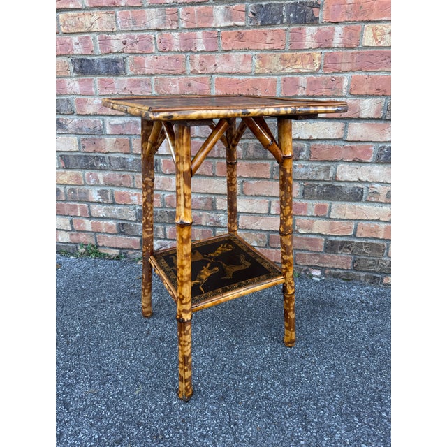 This is a beautifully decoupage English bamboo side table with dog motif. The antique yellow against the black background...