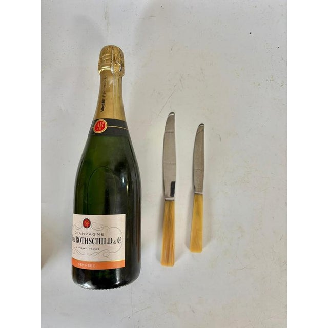 Set of 21 knives. This is a stainless steel knife set made in France in the 1970s. The handles are made of beige bakelite....