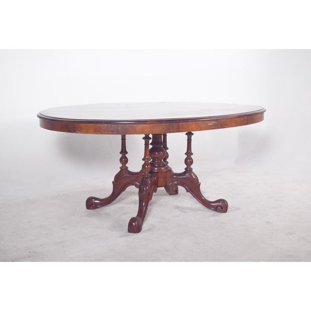 Antique oval dining table dates from the Victorian period, circa 1890, and has been constructed using the finest walnut....