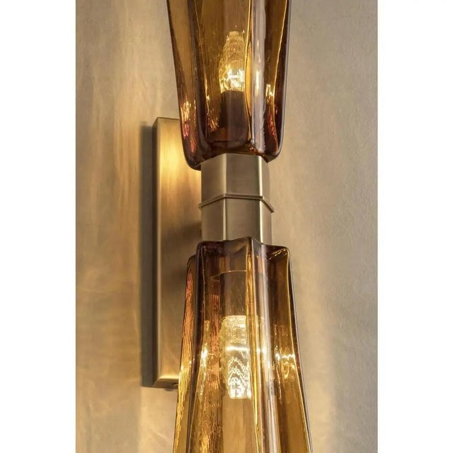 Elegant wall sconce in amber murano glass made in brunish- brunito metal frame. for classical and modern interiors, a...