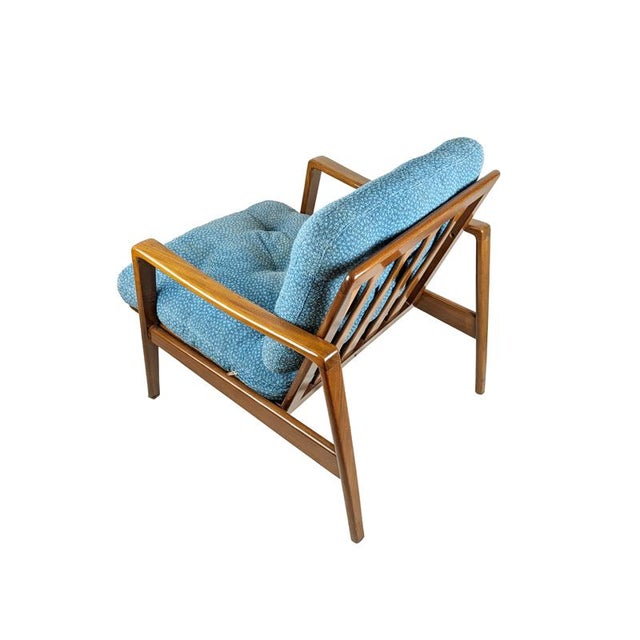 Removable armchair with teakwood structure and cushioned seat and backrest upholstered with light blue fabric (defects)....