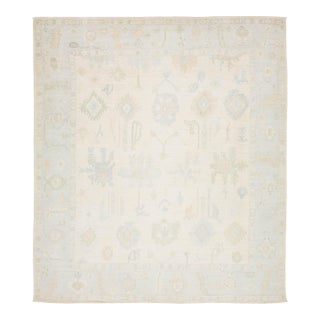 Artisanal Oushak Style Wool Area Rug: Neutral Ivory With Muted Floral Motifs For Sale