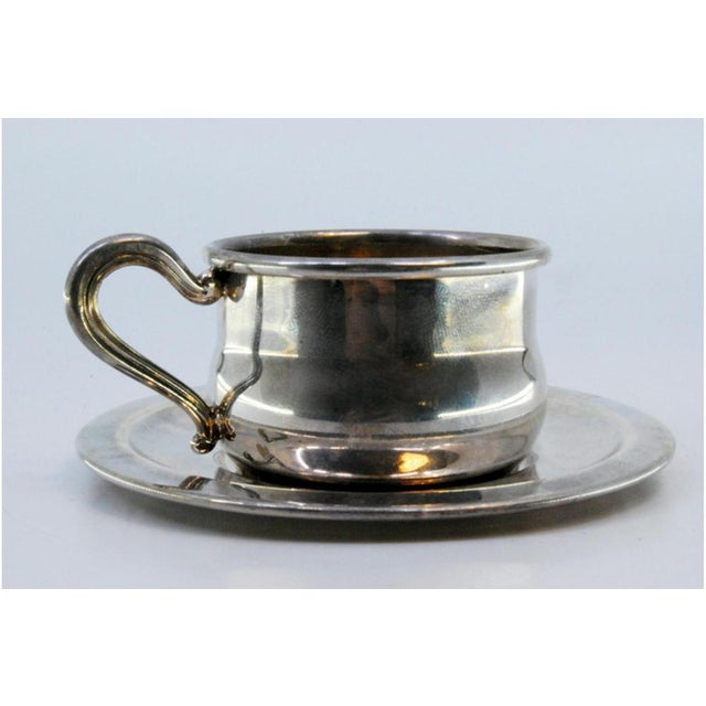 Cup and Saucer in Plain Silver with Embossed Handle, in Very Good conditions. Designed 1980 to 1989 This piece has an...