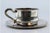 Cup and Saucer in Plain Silver with Embossed Handle, in Very Good conditions. Designed 1980 to 1989 This piece has an...