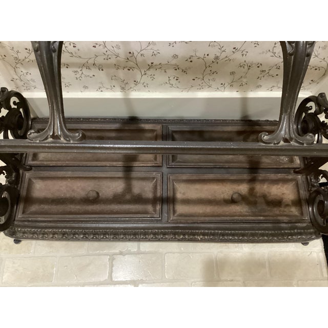This Victorian Rococo French-inspired scrollwork Cast Iron Umbrella Stand from the 1800s is a rare and unique piece of...