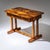Biedermeier desk, veneered in walnut, with one drawer and double fluted column legs at the sides, connected by a...
