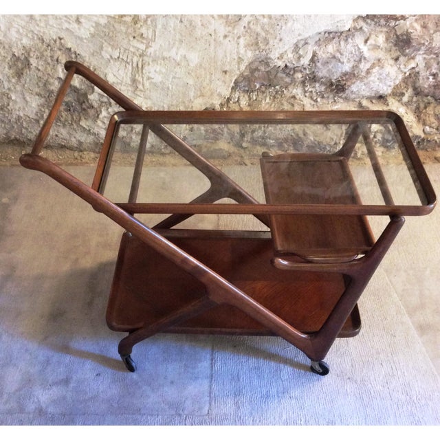 Mid Century Serving Bar cart by Cesare Lacca for Cassina. Wooden structure with glass top. It has a removable tray. Good...