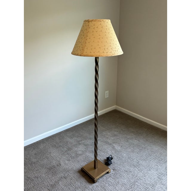 Elegant twisted bronze-tone floor lamp attributed to Baker Furniture, featuring a sculptural spiral column raised on a...
