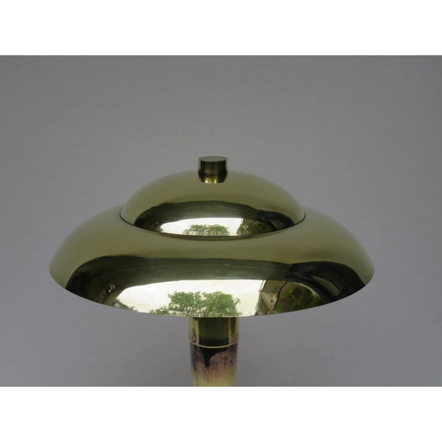 This imposing French table lamp is made from partly patinated brass in the Art Deco style. The piece features two bayonet...