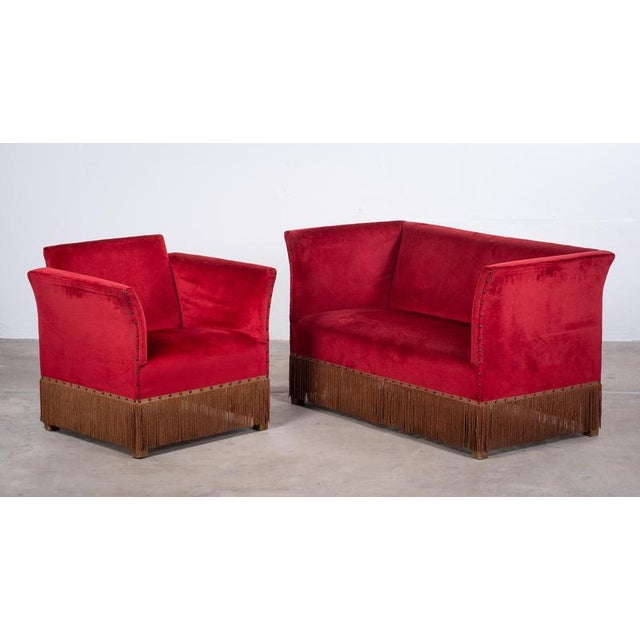A beautifully preserved Danish sofa and lounge chair set from the 1950s, upholstered in vibrant red velvet. Showcasing...