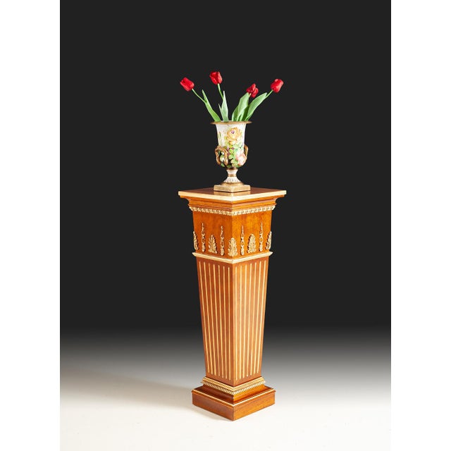 Handcrafted in Italy, this pedestal features a fluted column accented with gold leaf detailing. Its tapered form and...