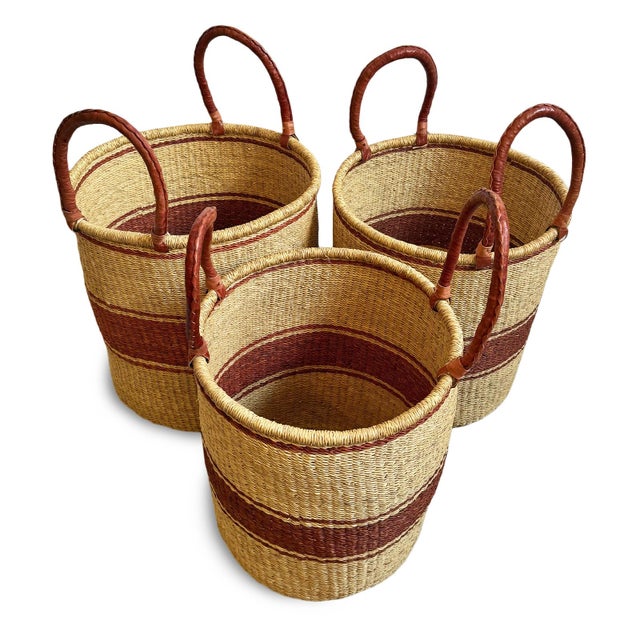 Handwoven seagrass authentic Bolga laundry or storage baskets. Each has sturdy leather wrapped handles for easy carrying....