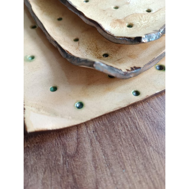 Set of three multipurpose plates. Suitable as a cheese bowl, candle holder, or storage container. The piece is entirely...