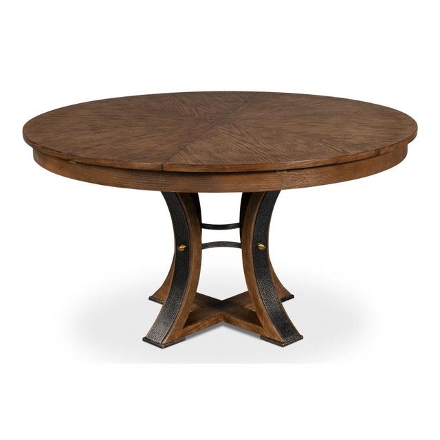 Light brown wood softens the strong outline of an iron-banded pedestal. A curved four-post pedestal sweeps outward from a...