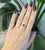 A 0.89ct zambian emerald round ring set in solid 14K yellow gold, set with six earth mined diamonds. Emerald, the May...