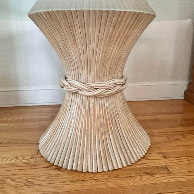 Sculptural sheaf of wheat dining pedestal table, in the style of McGuire. This Palm Regency style table features twisted...