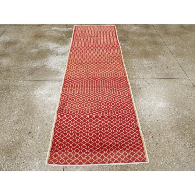 A vintage Turkish Anatolian rug from the second half of the 20th century with a diamond pattern set on a brick ground....