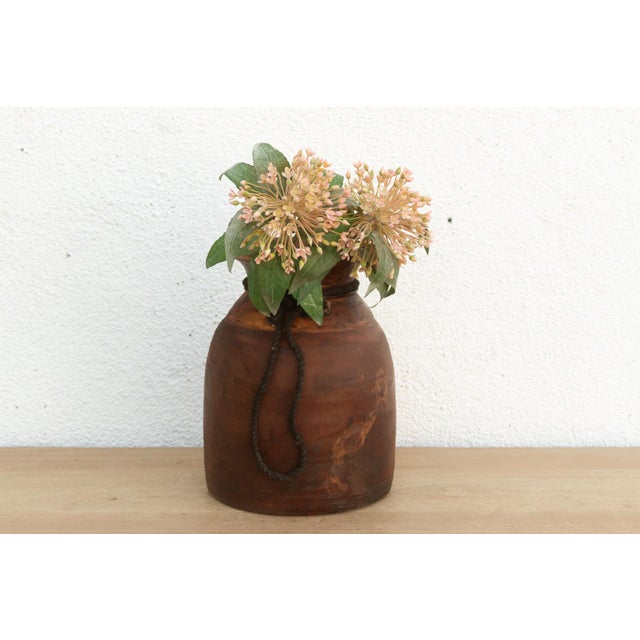 Originally used in village homes for storing milk, ghee, or grains, this antique wooden pot has survived generations of...