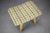 Mid-Century upholstered stool manufactured in Czechoslovakia during the 1970s. The piece features a sculptural padded seat...