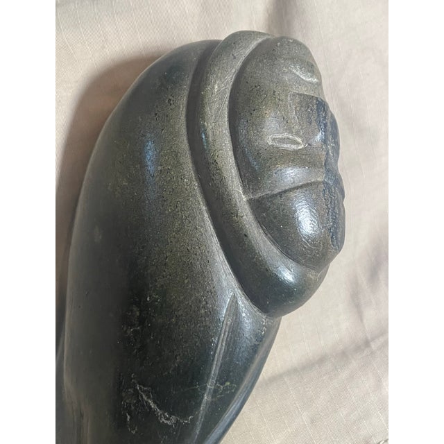 This stone carving represents the rich artistic tradition of Inuit sculpture that has been practiced for thousands of...