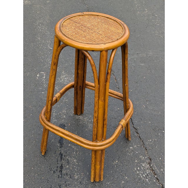 Elevate your interior with the organic warmth of this stunning vintage bohemian bamboo stool. Featuring a classic...