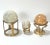 A wonderful collection of solid stone spheres in varying sizes and heights. All three are showcased on a vintage brass...