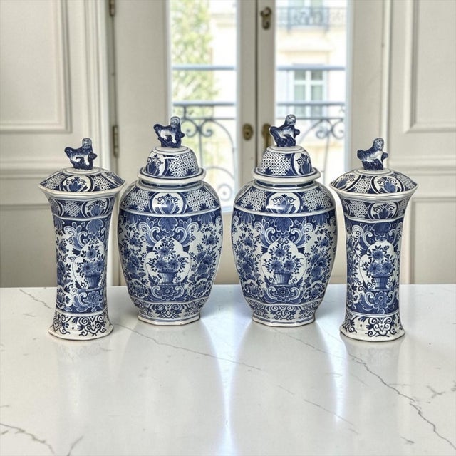 Refined 19th century Belgian Boch faience garniture offers the timeless beauty of hand-painted blue and white Delft...
