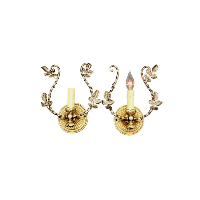 Lovely solid cast brass petit wall sconces with original finish. Twisting vines is the motif with detailed cast brass...