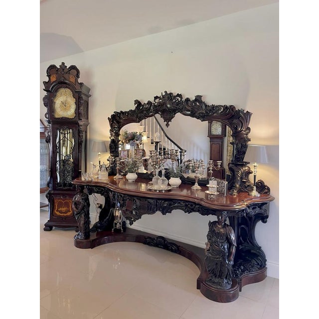 Farming tools are carved on the base of the mirror frame above a fantastic serpentine shaped top with a double moulded...