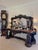 Farming tools are carved on the base of the mirror frame above a fantastic serpentine shaped top with a double moulded...
