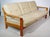Scandinavian 1970s three-seater sofa made of solid teak. Generously sized with six cushions on a sturdy wooden frame....