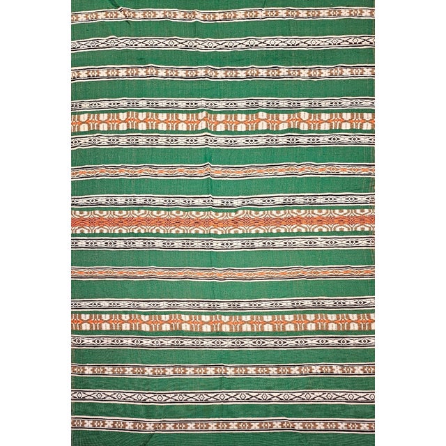 63” x 101” Vintage Southwestern Kilim in alternating band pattern in green, ivory, brown, orange, and black colors. It was...