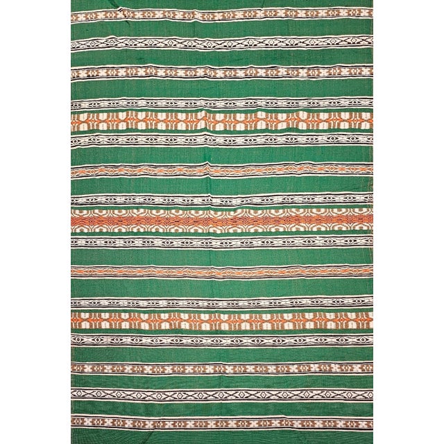 63” x 101” Vintage Southwestern Kilim in alternating band pattern in green, ivory, brown, orange, and black colors. It was...