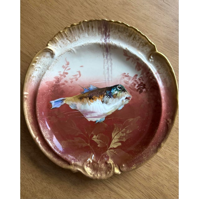 A stunning French Limoges fish service consisting of five hand-painted plates and a coordinating gravy boat. Each piece is...