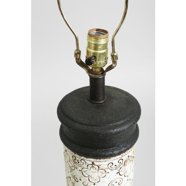 Italian ceramic lamps attributed to Aldo Londi for Bitossi, defined by cylindrical forms and hand drawn repeating motifs....