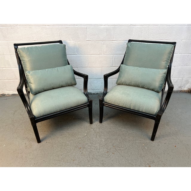 This pair of Hollywood Regency Style accent armchairs features an ebonized bamboo frame with distinctive fretwork lattice...