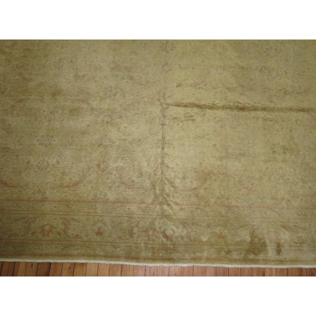 A very finely woven Turkish rug with a muted formal repetitive palette in creamy yellow, pinky rose tones . It has a very...